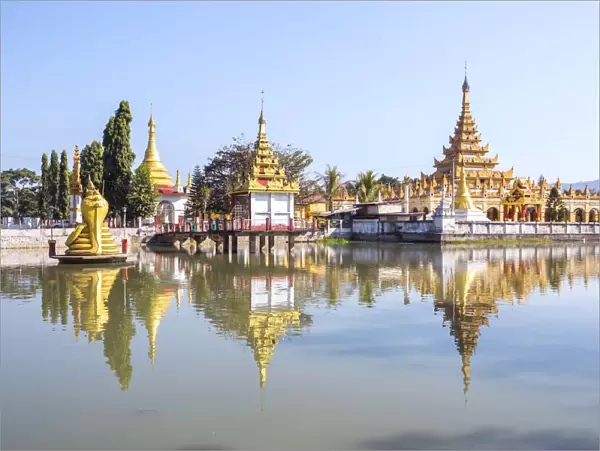 Myanmar, Hsipaw. Buddhsit pagodas reflected into small lake