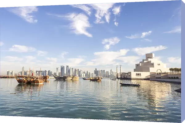 Qatar, Doha. View of the harbour with the city in the background and the museum of