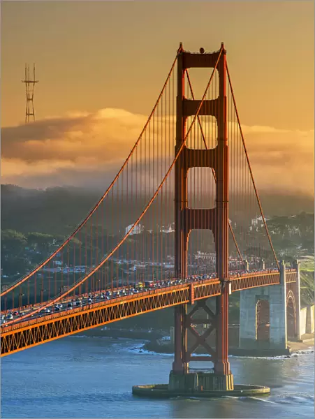 Sunset view over the Golden Gate with fog in the background, San Francisco, California