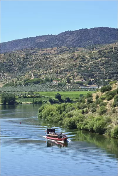 The Douro river and a tour boat at Pocinho, a Unesco World Heritage Site. Portugal