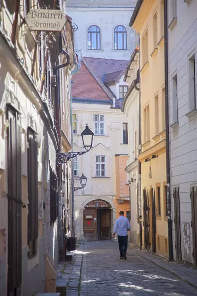 Man walking along street in Old Town, Bratislava, Slovakia