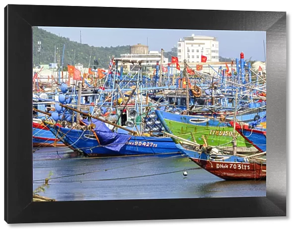 Asia, South East Asia, Vietnam, Danang, wooden fishing boats in harbour flying Vietnamese