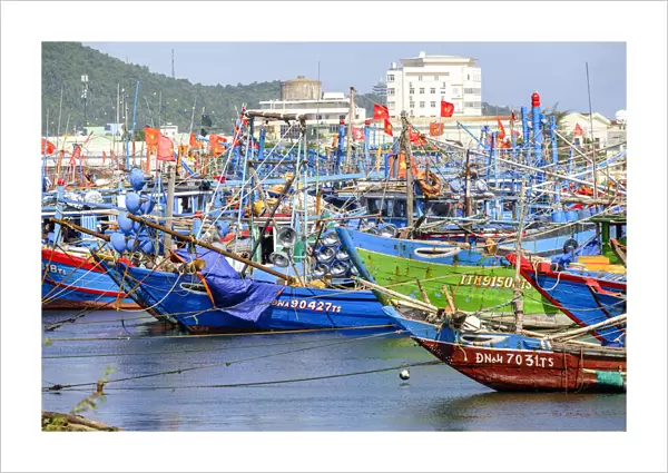 Asia, South East Asia, Vietnam, Danang, wooden fishing boats in harbour flying Vietnamese