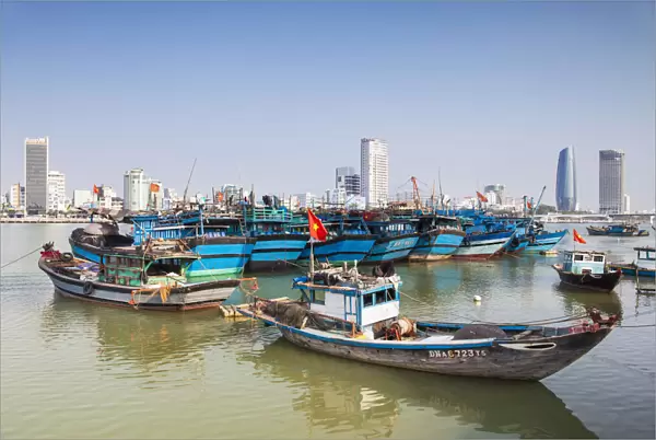 Fishing boats on Song River and city skyline, Da Nang, Vietnam