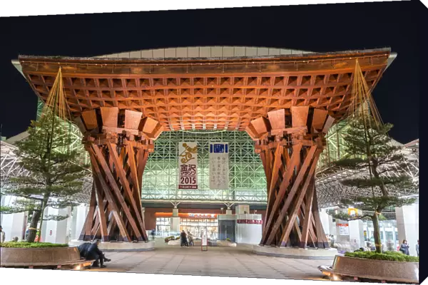 Night view of huge wooden gate marking the entrance to Kanazawa JR Station Building