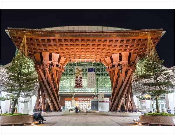 Night view of huge wooden gate marking the entrance to Kanazawa JR Station Building