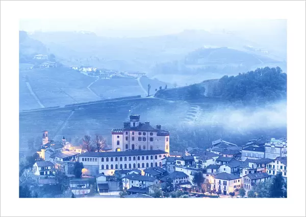 Castle and village of Barolo during a foggy dusk. Barolo wine region, Langhe, Piedmont