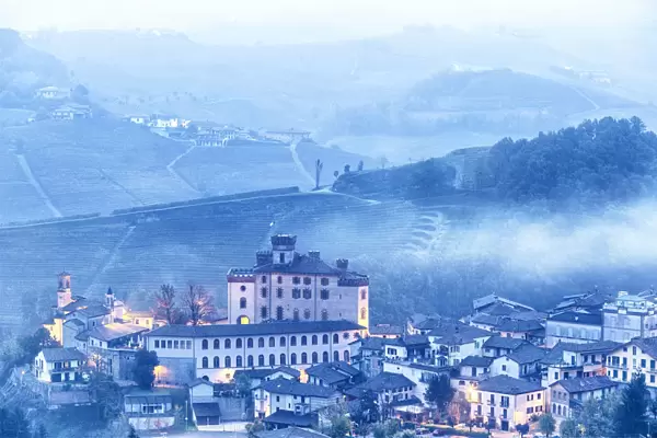 Castle and village of Barolo during a foggy dusk. Barolo wine region, Langhe, Piedmont