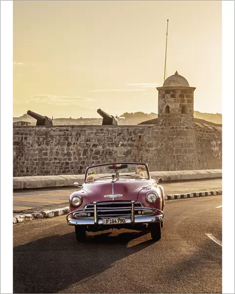 Vintage Car at El Malecon with San Salvador de la Punta Castle in the background, sunrise