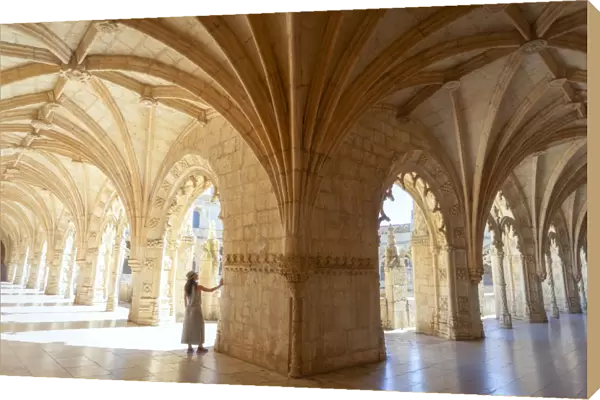 A tourist observes the columns of the cloister of the Mosteiro dos Jeronimos (Jeronimos Monastery), Santa Maria de Bel√©m, Lisbon, Lisbon Metropolitan Area, Portugal