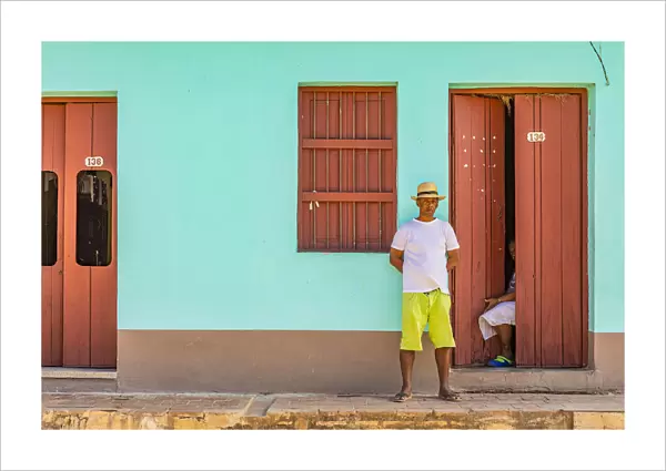 A man standing outside his house in a street in Trinidad, Sancti Spiritus, Cuba