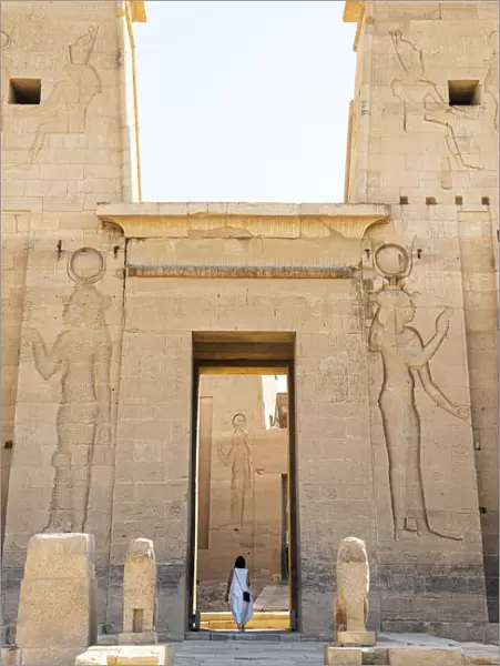 Tourist walking throuhg the Temple of Philae on an island in Lake Nasser, Nile River