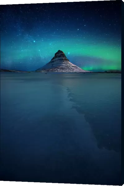 Northern lights over the Kirkjufell mountain in winter, Snaefellsnes Peninsula, Iceland