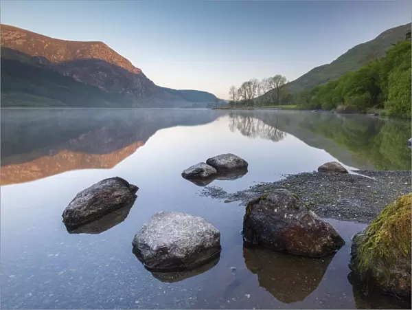 Mirror reflections at dawn on Llyn Cwellyn in Snowdonia National Park, Wales, UK. Spring