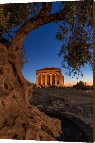 Agrigento, Sicily. People visiting Concordia Temple in the Valley of Temples at dusk