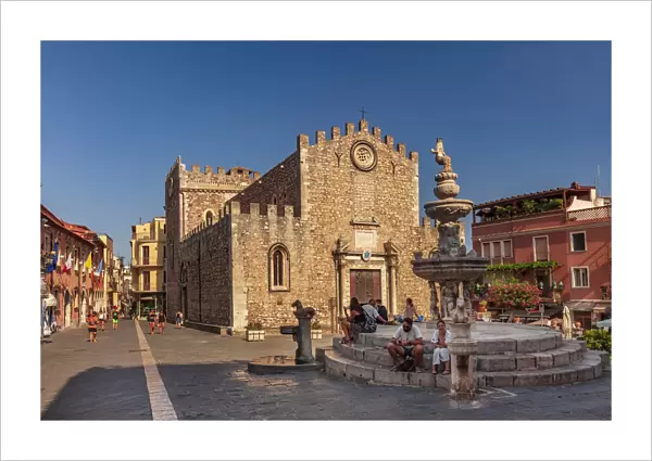 Taormina, Sicily. people sitting on the fountain near the Cathedral