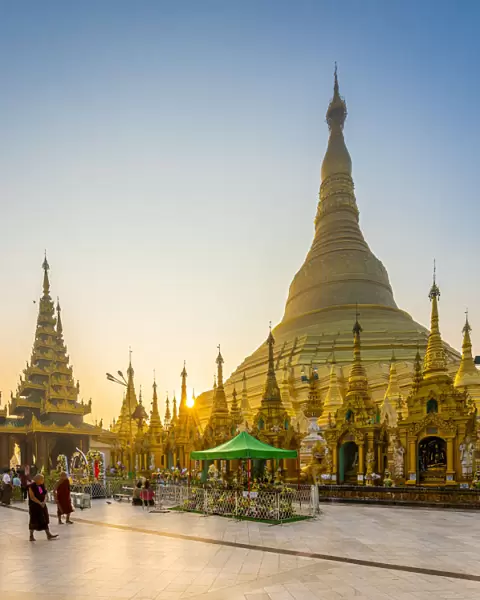 Tourists at golden Shwedagon Pagoda against clear sky at sunrise, Yangon, Yangon Region