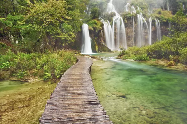 Waterfall and wooden footbridge - Croatia, Lika-Senj, Plitvice Lakes - Plitvice Lakes