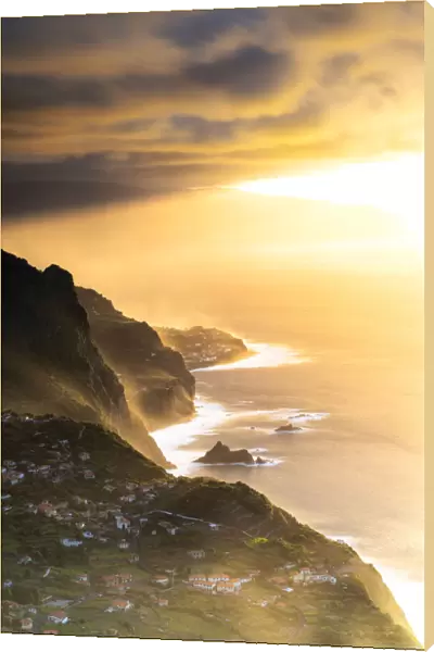 Sunset over Arco de Sao Jorge and Ponta Delgada on cliffs above the ocean, Madeira island