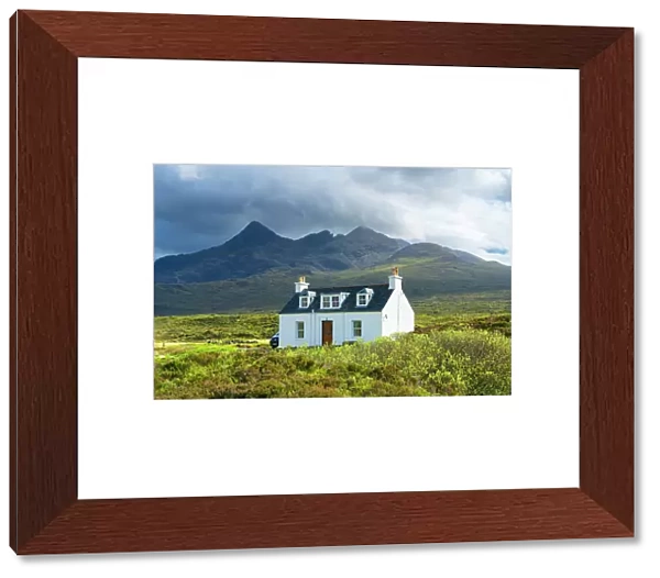 Cottage with Cuillin mountain range in background, near Sligachan, Isle of Skye, Scottish Highlands, Scotland, UK