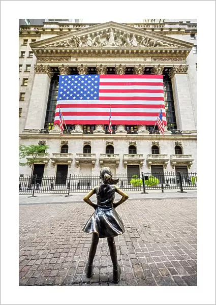 'Fearless Girl'bronze sculpture by artist Kristen Visbal across from the New York Stock Exchange Building, Lower Manhattan, New York, USA