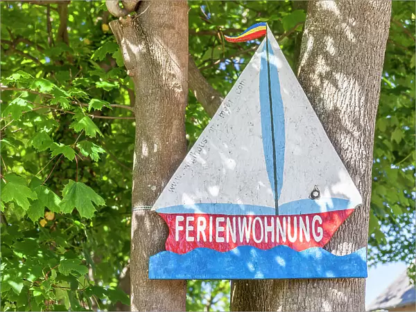 Wooden sign holiday apartment with motif sailing ship in Ahrenshoop, Mecklenburg-Western Pomerania, Baltic Sea, Northern Germany, Germany