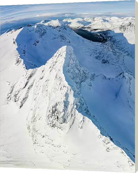 Aerial panoramic view of Litjemoa mountain peak covered with snow, Bergsfjorden, Senja, Troms county, Norway