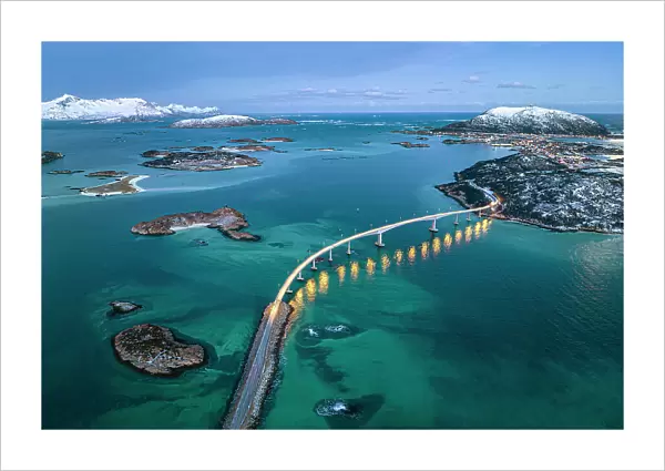 Aerial view of Sommaroy island and majestic bridge along a fjord in winter, Troms county, Norway