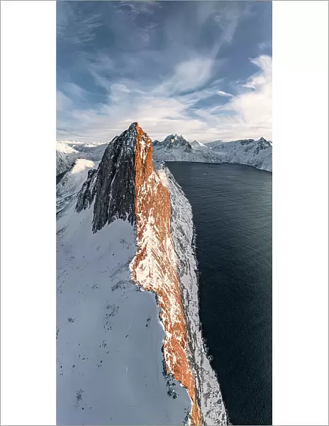 Overhead view of steep ridge of Segla mountain covered with snow at sunset, aerial view, Senja, Troms county, Norway