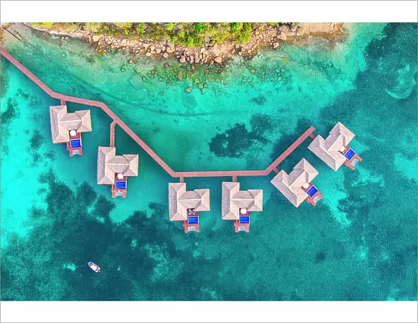 Overwater luxury bungalows with private pool in the crystal clear sea, aerial view, Antigua, Antigua & Barbuda, Caribbean