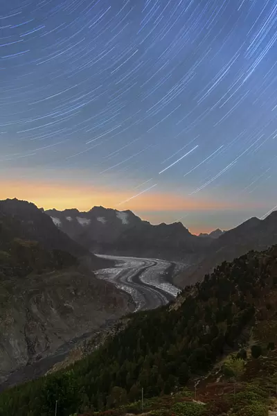 Star trail above the glacial tongue of the Aletsch glacier, Bernese Alps, Valais canton, Switzerland