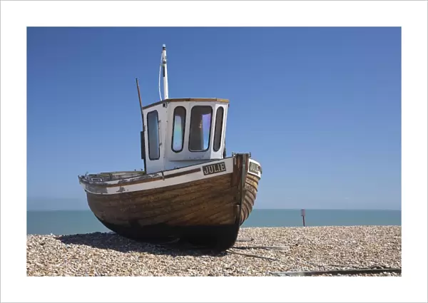 England, Kent, Deal. Old wooden fishing boat on the shingle beach at Deal