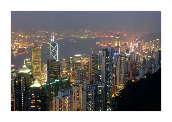 Hong Kongs modern skyline overlooking Victoria harbour and Kowloon peninsula at night, Hong Kong