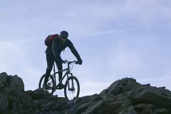 A mountain biker descending Helvellyn in the Lake District UK