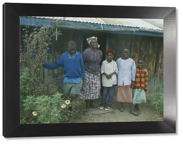 20053301. KENYA Families Portrait of rural family standing outside house near Bomet