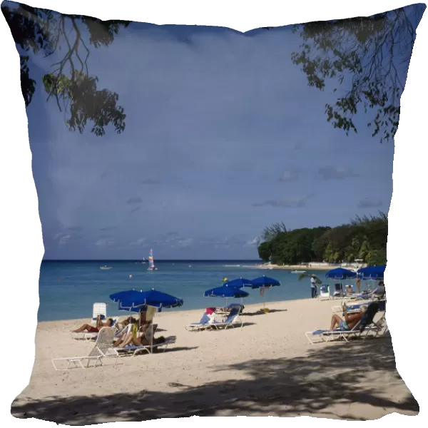 10002488. BARBADOS St James Sandy Lane beach sunbathers blue umbrellas overhanging trees