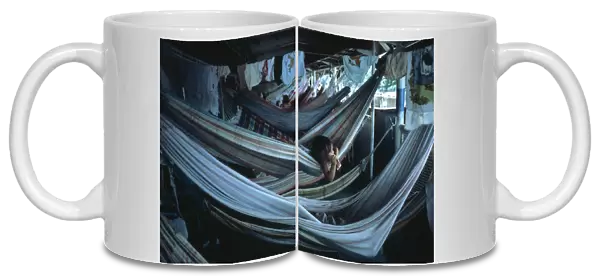 BRAZIL, Amazon, Transport Child lying in hammock accommodation on Amazon river boat