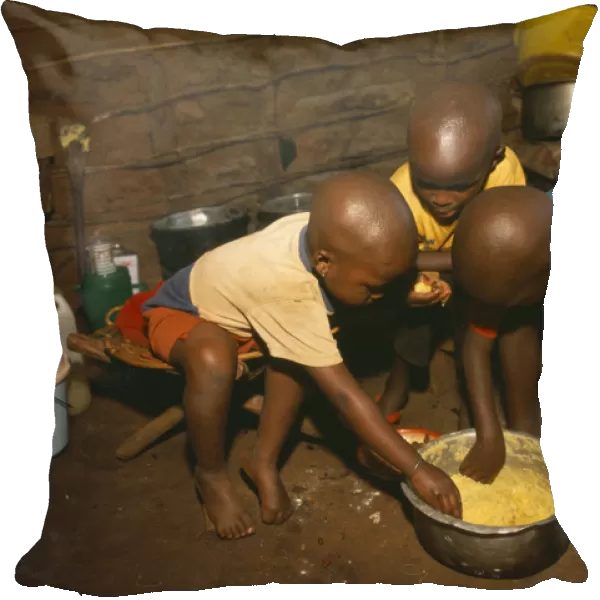 20062740. TANZANIA West Great Lakes Region Refugee children eating maize porridge