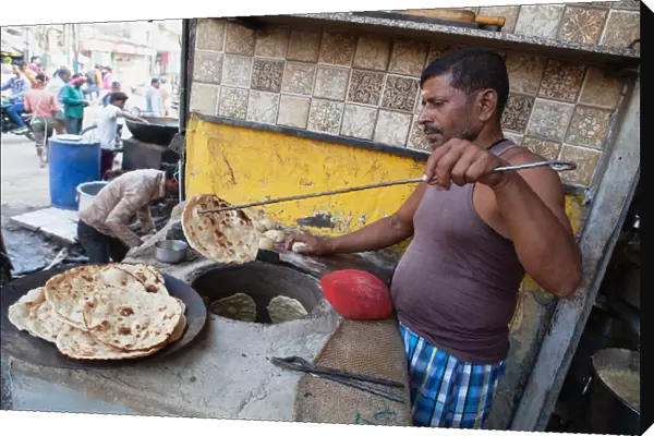 India, Uttar Pradesh, Varanasi, A cook making tandoori roti at a food hotel