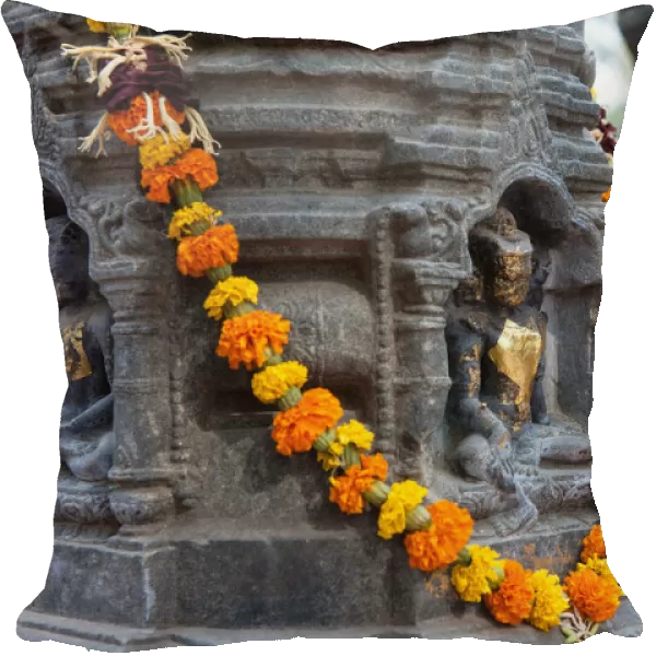 India, Bihar, Bodhgaya, Garland of marigolds wrapped around a stupa at the Mahabodhi Temple in Bodhgaya