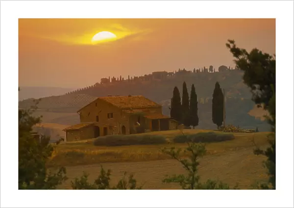 20073887. ITALY Tuscany Farmhouse and cypress trees at sunset near San Quirico d Orcia