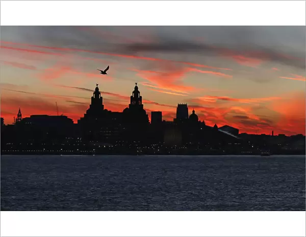 The sun rises across the river Mersey over Liverpool