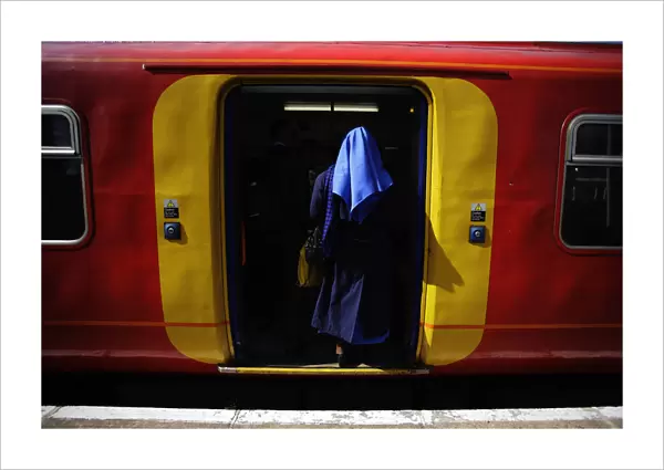 A nun boards a train at Strawberry Hill station following Pope Benedict XVIs arrival