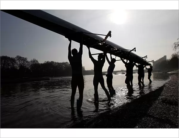 The Cambridge University rowing crew prepare for a training session on the River Thames