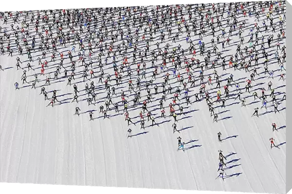 Cross-country skiers start during the Engadin Ski Marathon on the frozen Lake Sils