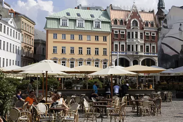 Tourists rest at the open-air cafe in downtown Riga