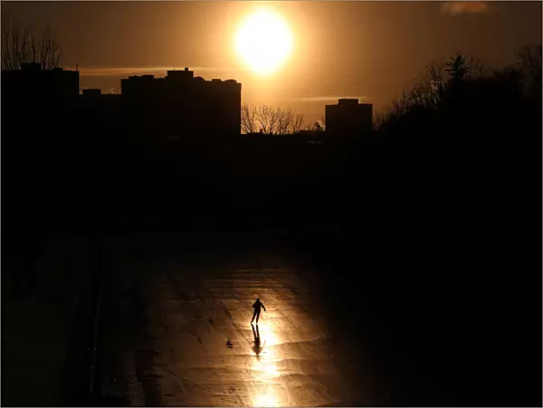 A person casts a shadow while skating on the Rideau Canal in Ottawa