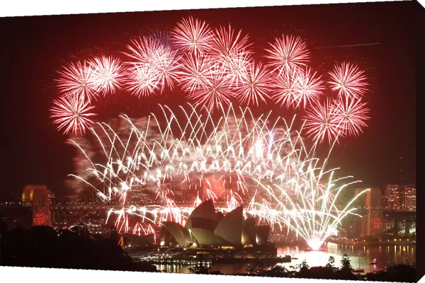 Fireworks explode over the Sydney Harbour Bridge and Opera House during a pyrotechnic