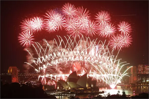 Fireworks explode over the Sydney Harbour Bridge and Opera House during a pyrotechnic