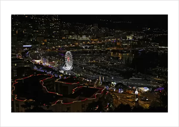 Christmas decorations and a Ferris wheel light the port of Monaco during holiday season